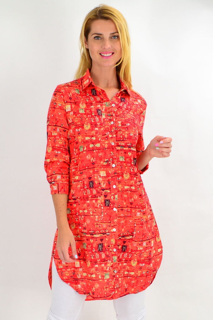 Long orange abstract tunic shirt by Ruby Rain, featuring a vibrant red and orange pattern, perfect for summer casual wear.