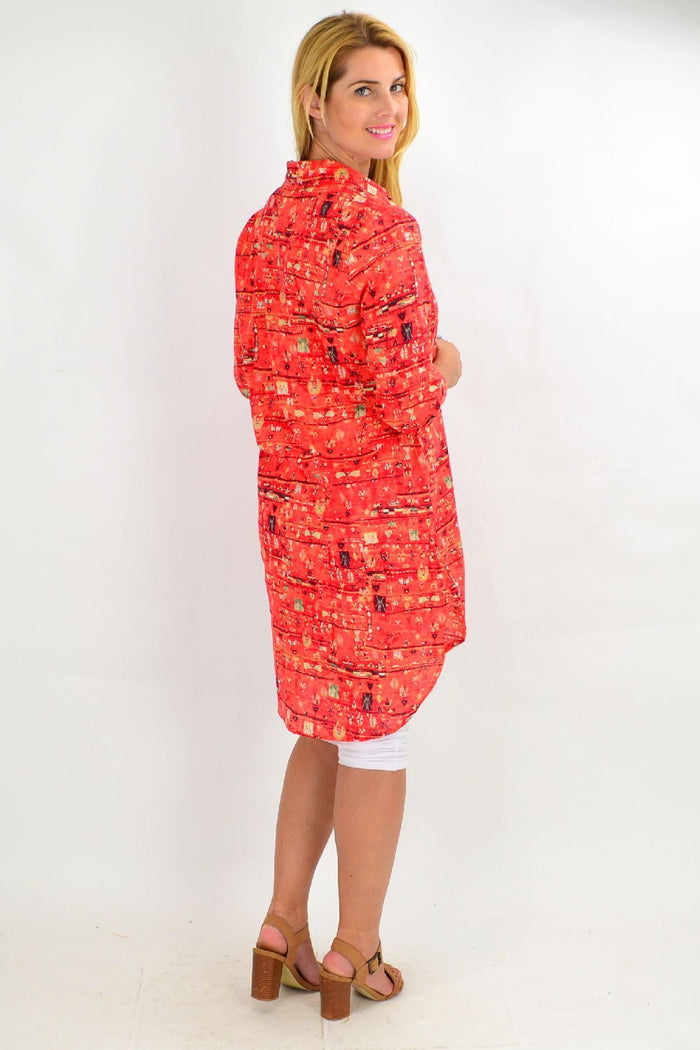 Long orange abstract tunic shirt by Ruby Rain, featuring a flowing design and vibrant color, perfect for summer wear.