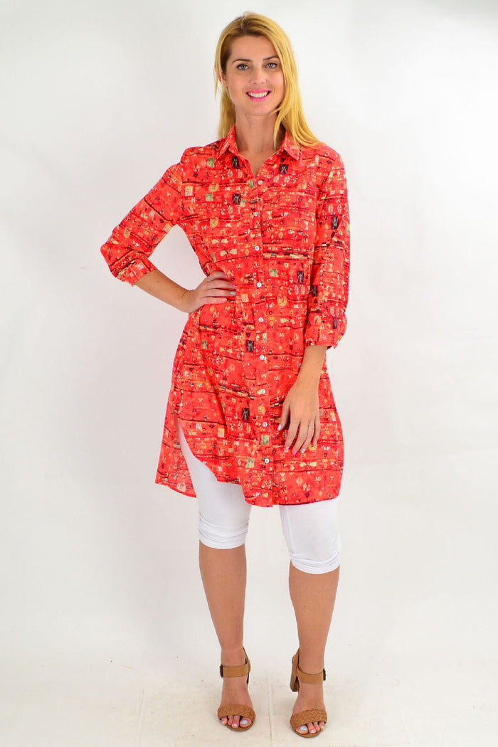 Long orange abstract tunic shirt by Ruby Rain, featuring a vibrant red-orange design and relaxed fit for summer wear.