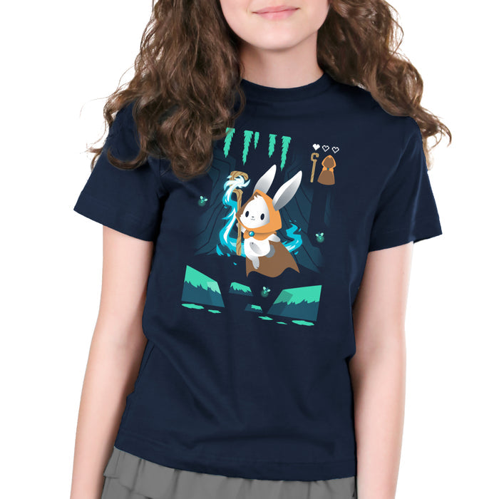 Premium Cotton T-shirt_TeeTurtle Mage Class navy blue apparel featuring an adventurous magical bunny holding a staff and skipping across a river and surrounded by fireflies.