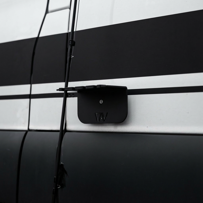Magnetic fly rod holder by Storyteller mounted on the side of a van with fishing rods attached