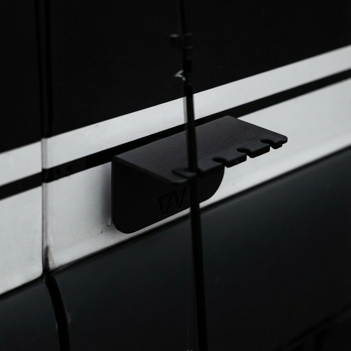 Revel magnetic fly rod holder mounted on the side of a van with a fly rod in place