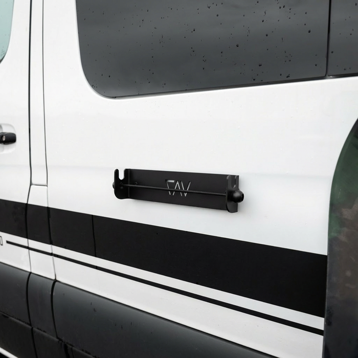 CAV magnetic ski and snowboard holder mounted on the side of a white van