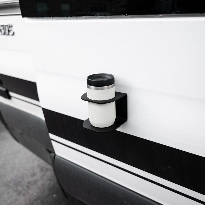 Magnetic Solo Cupholder by GH1 attached to a van exterior holding a travel mug