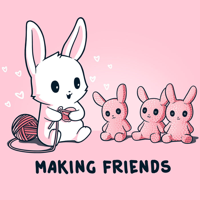 Premium Cotton T-shirt_Teeturtle light pink Making Friends apparel featuring a white bunny knitting 3 bunny friends out pink of yarn, caption reads, "Making Friends'.