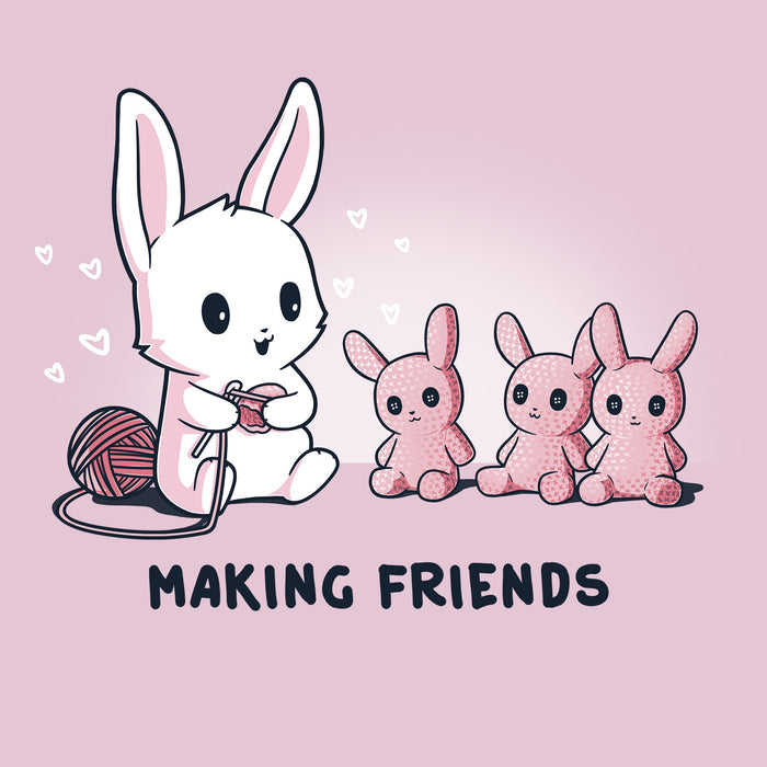 Classic Cotton T-shirt_Teeturtle light pink Making Friends apparel featuring a white bunny knitting 3 bunny friends out pink of yarn, caption reads, "Making Friends'.