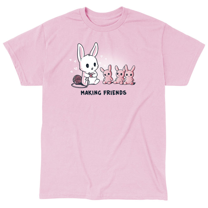 Classic Cotton T-shirt_Teeturtle light pink Making Friends apparel featuring a white bunny knitting 3 bunny friends out pink of yarn, caption reads, "Making Friends'.