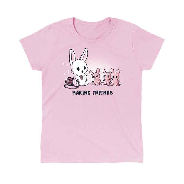 Classic Cotton T-shirt_Teeturtle light pink Making Friends apparel featuring a white bunny knitting 3 bunny friends out pink of yarn, caption reads, "Making Friends'.