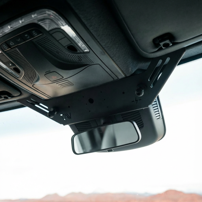 NAV-Mount V2 installed above rearview mirror in a van interior ceiling console.