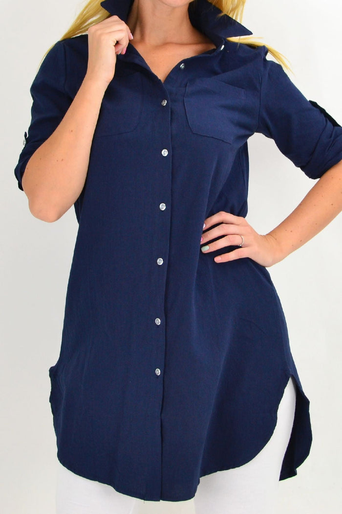 Navy blue summer tunic shirt by Ruby Rain, lightweight and casual, shown hanging on a wooden hanger.