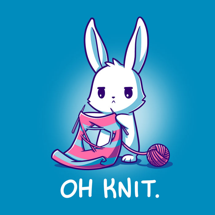 Premium Cotton T-shirt_Teeturtle cobalt blue Oh Knit apparel featuring a white rabbit looking distraught. It's holding two knitting needles attached to a blue and pink striped scarf that has a large hole in the middle. There is a ball of pink yarn trailing off to the side and text beneath it that says "Oh knit."