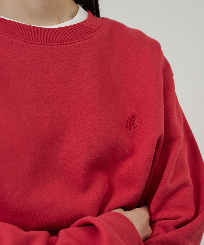 Model wearing a Gramicci crimson red One Point Crew Sweatshirt against a light-tone background.