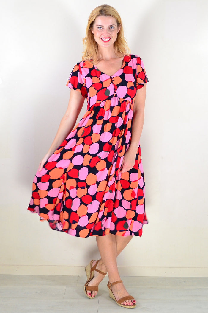 Pink orange spots tunic dress by Hourglass featuring a relaxed fit and vibrant pattern, displayed on a mannequin.