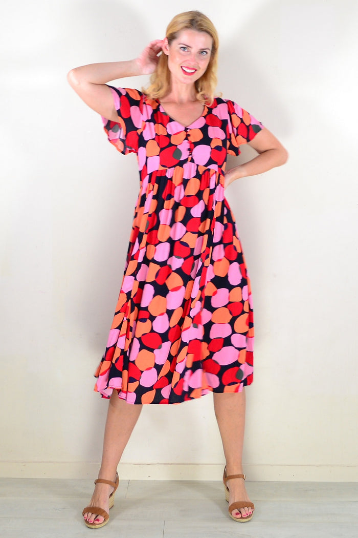 Pink and orange spotted tunic dress by Hourglass, featuring a flowy, lightweight fabric and a relaxed fit.