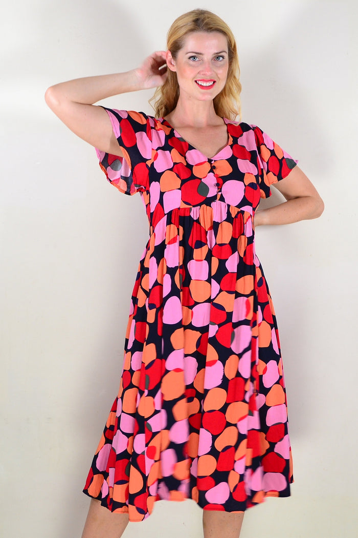 Pink orange spots tunic dress by Hourglass, showing a stylish, flowy tunic with vibrant spot pattern and soft fabric.