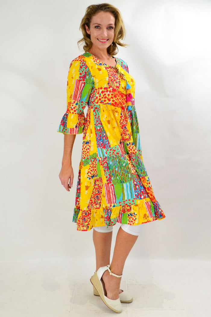 Wishstone Sandy Beach tiered tunic dress displayed on a hanger, featuring lightweight fabric and layered design perfect for summer wear.