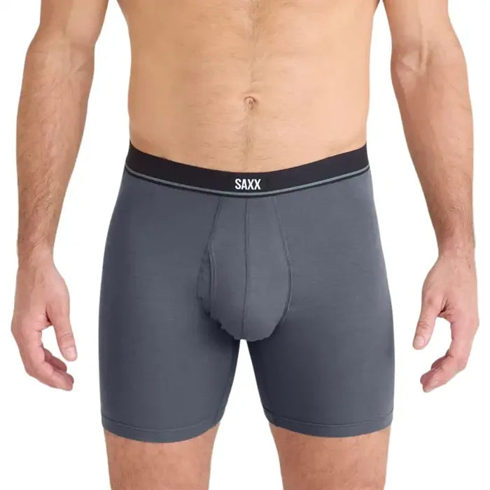 Man wearing Grey boxer briefs with a black waistband featuring the SAXX logo