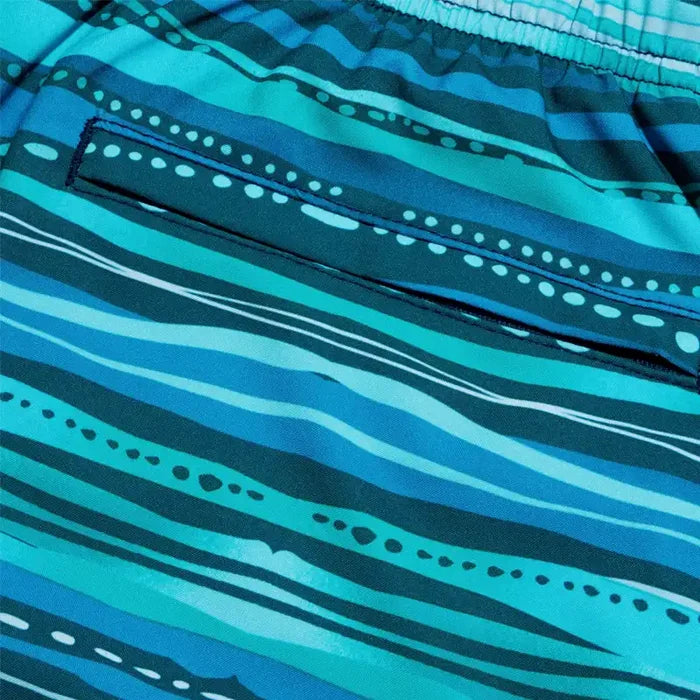 Close-up of blue swim shorts with wave pattern