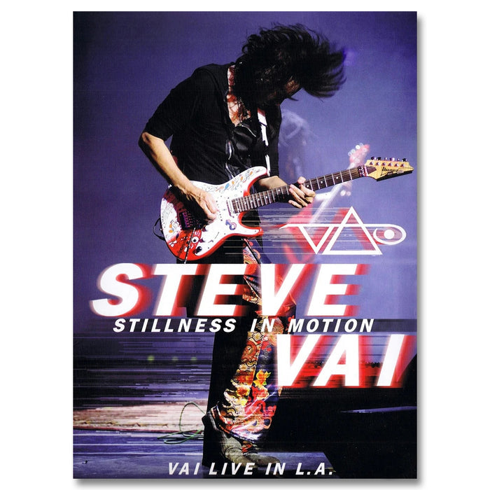 steve vai stillness in motion album artwork. steve vai plays electric guitar against a grey and blue background. his hair is flipped up in the air. below steve in red and white text reads "steve vai, stillness in motion, vai live in LA: deluxe". the steve vai logo in red and white is above this text. the logo makes the word "vai" with an upside down triangle, a right side up one, and a line going across the triangles with a curl at the end next to the triangle that is upright.