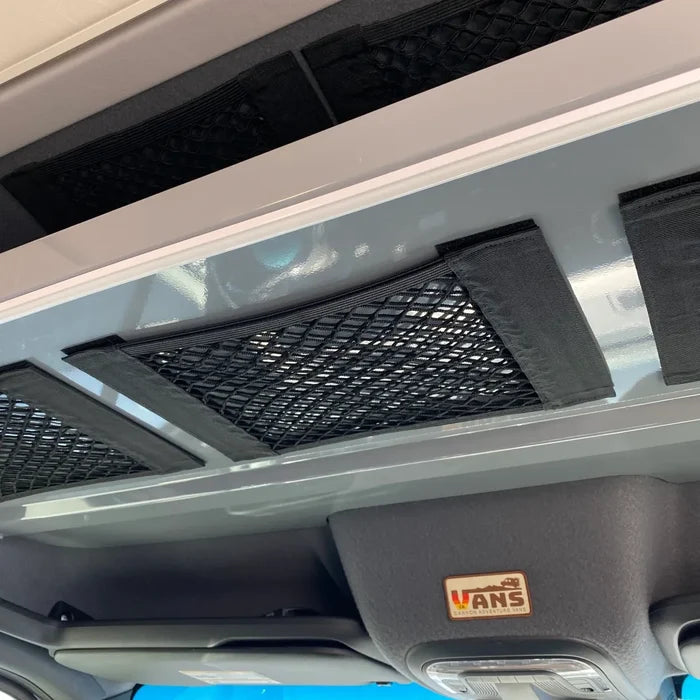 Canyon Adventure Vans storage net mounted on van ceiling above the driver area.