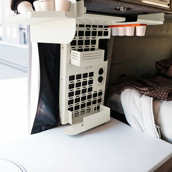CAV MOLLE panel Keurig pod holder mounted in a van interior near a sleeping area.