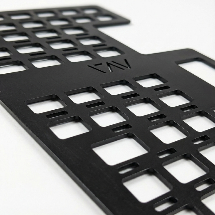 Close-up of black Storyteller Galley MOLLE Panel with cutout grid design and engraved logo.