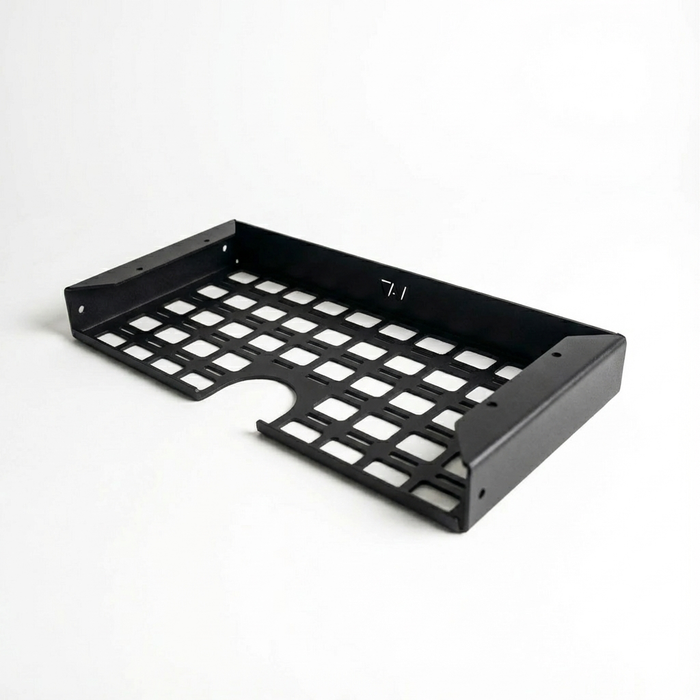 Storyteller undercabinet shelf for driver side, black metal with grid pattern and mounting holes.