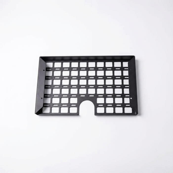 STO Undercabinet Shelf in black metal with grid design and cable cutout, viewed from above.