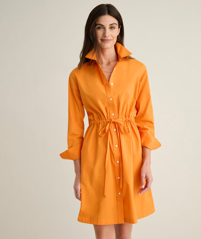 Model is wearing UNTUCKit Taylor dress in orange.