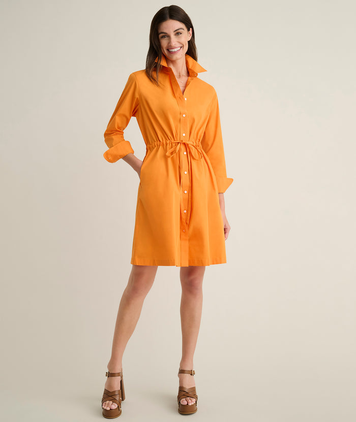 Model is wearing UNTUCKit Taylor dress in orange.