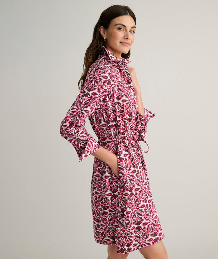 Model is wearing UNTUCKit Taylor dress in pink print.
