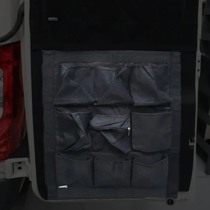 DOORGANIZER with multiple storage pockets attached to the interior van door.