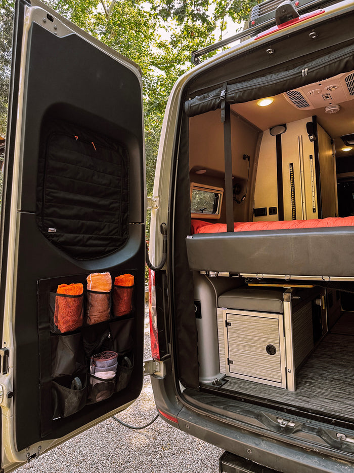 DOORGANIZER storage system by Gear Haul shown on van door with towels and travel gear inside pockets.