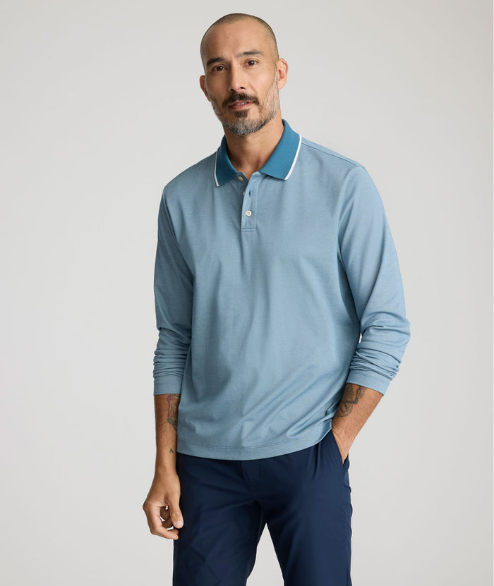 Model is wearing UNTUCKit LS Day Performance Polo in Real Teal.