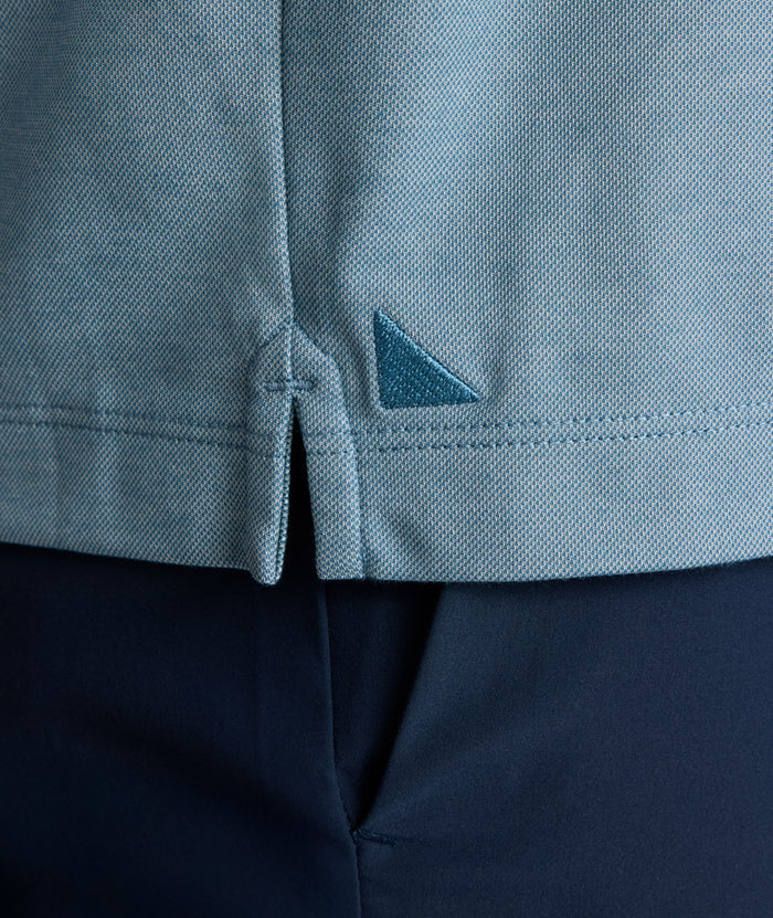 Model is wearing UNTUCKit LS Day Performance Polo in Real Teal.