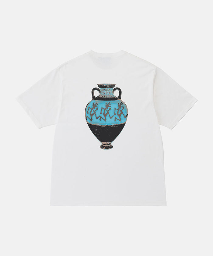 Back view of a Gramicci white Vase Tee with a graphic against a light-tone background.