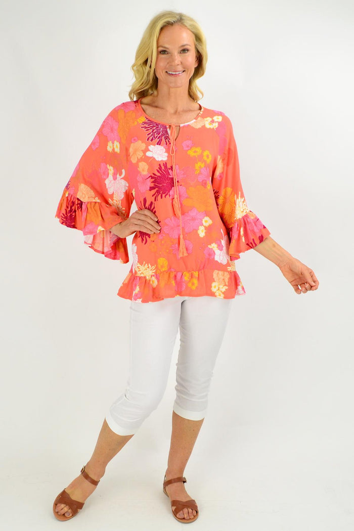 Apricot floral tunic top with wide sleeves from New U Collection, designed for a loose, comfortable fit for ladies.